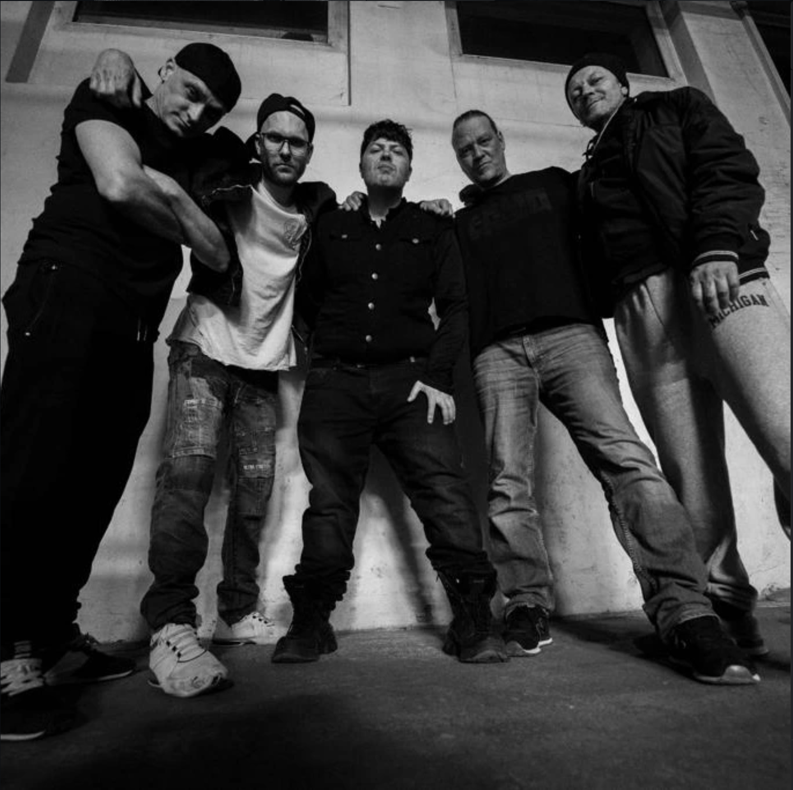 BROOK, the full band, standing together in a low-angle black and white portrait